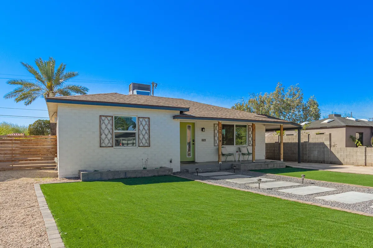 The front of the house is highlighted here, with a vibrant green door, decorative windows, and a tidy front yard. The inviting porch hints at a friendly, walkable neighborhood and provides a spot to relax after strolling local sidewalks and parks with a pet.